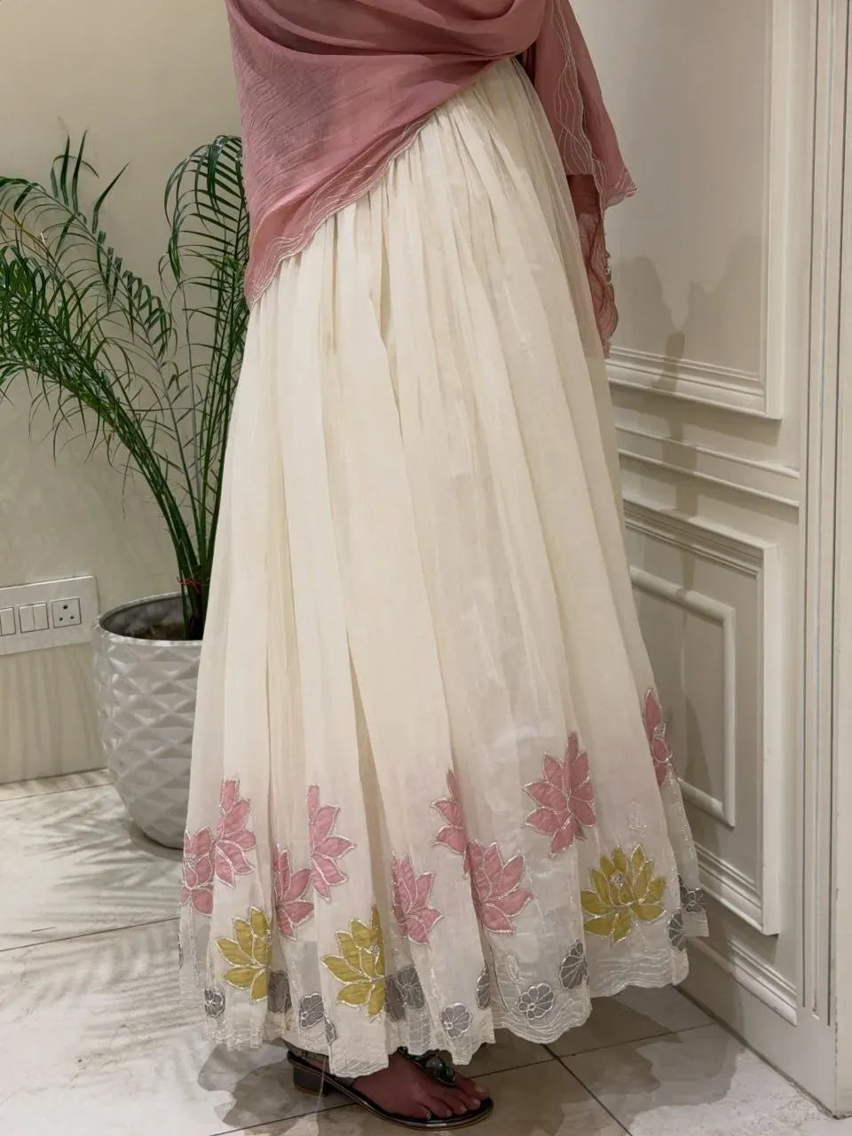 Model wearing white georgette gown with pink dupatta indoors
