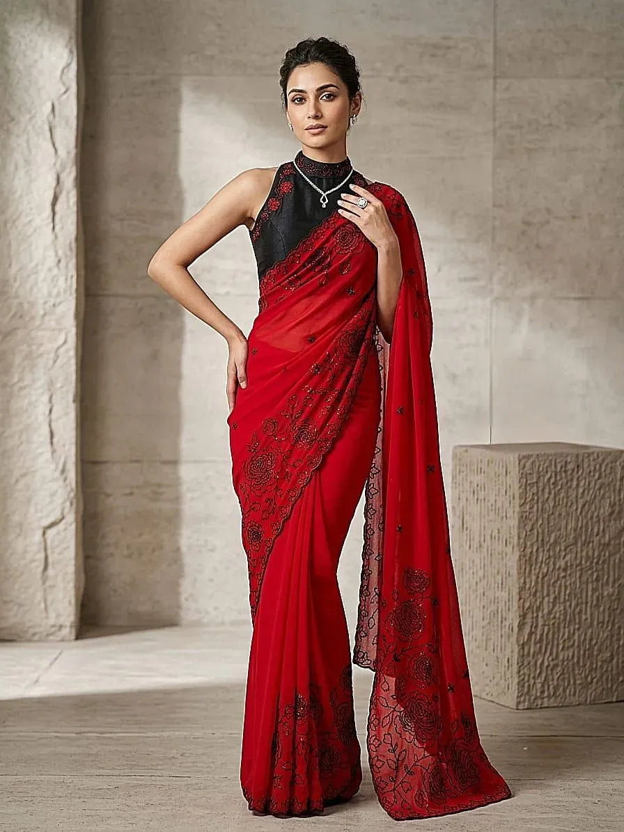 Model wearing red georgette saree with black embroidery and halter blouse