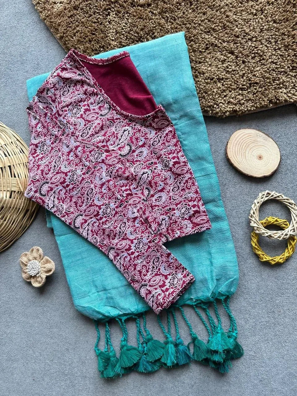Teal khadi cotton saree with tussles pallu and maroon paisley print long sleeve blouse
