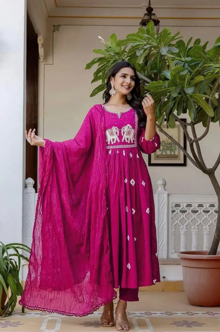 Model wearing bright pink heavy rayon kurti with foil work and matching dupatta outdoors