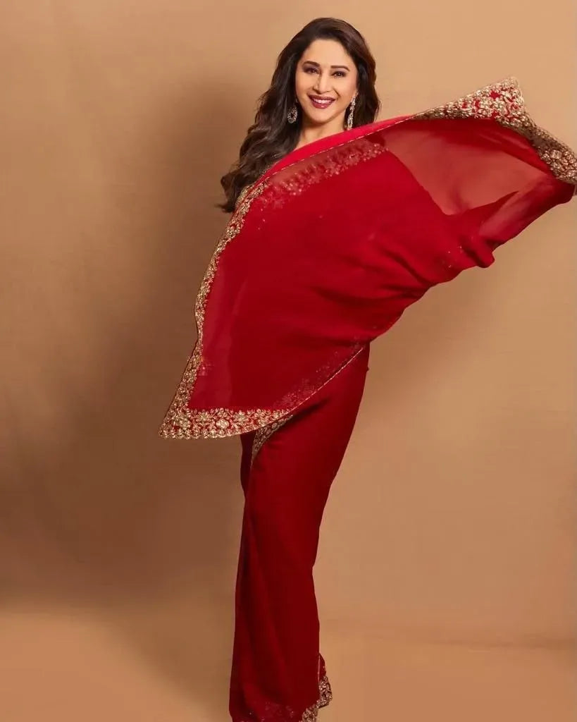 Full body shot of model gracefully posing in red heavy embroidery georgette saree