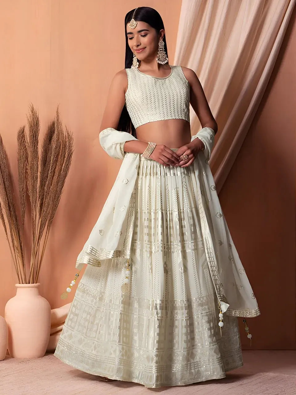Model wearing ivory sequin designer lehenga choli with dupatta