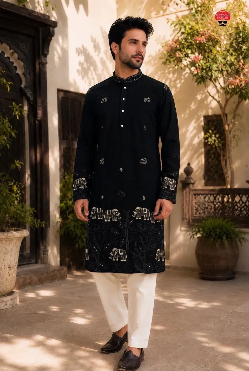 Man wearing black kurta pyjama with heavy embroidery and white pants