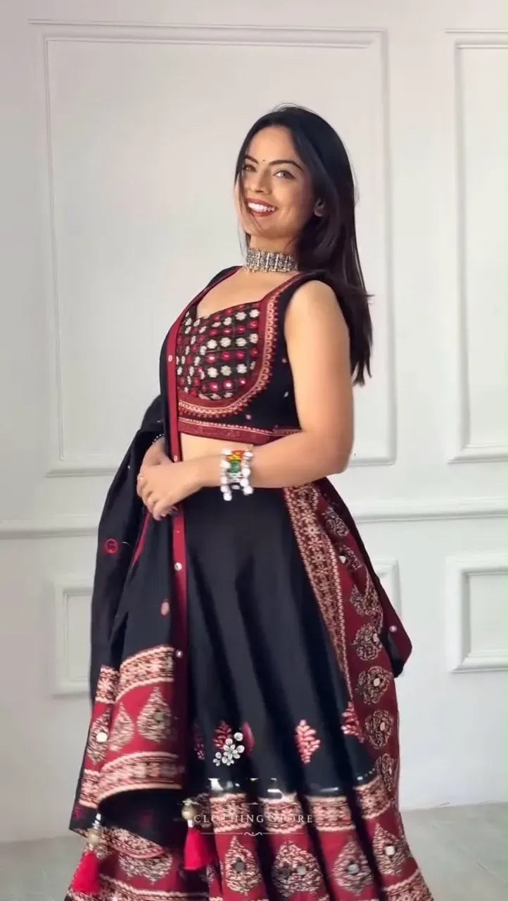 Model wearing black and maroon designer lehenga choli with mirror work