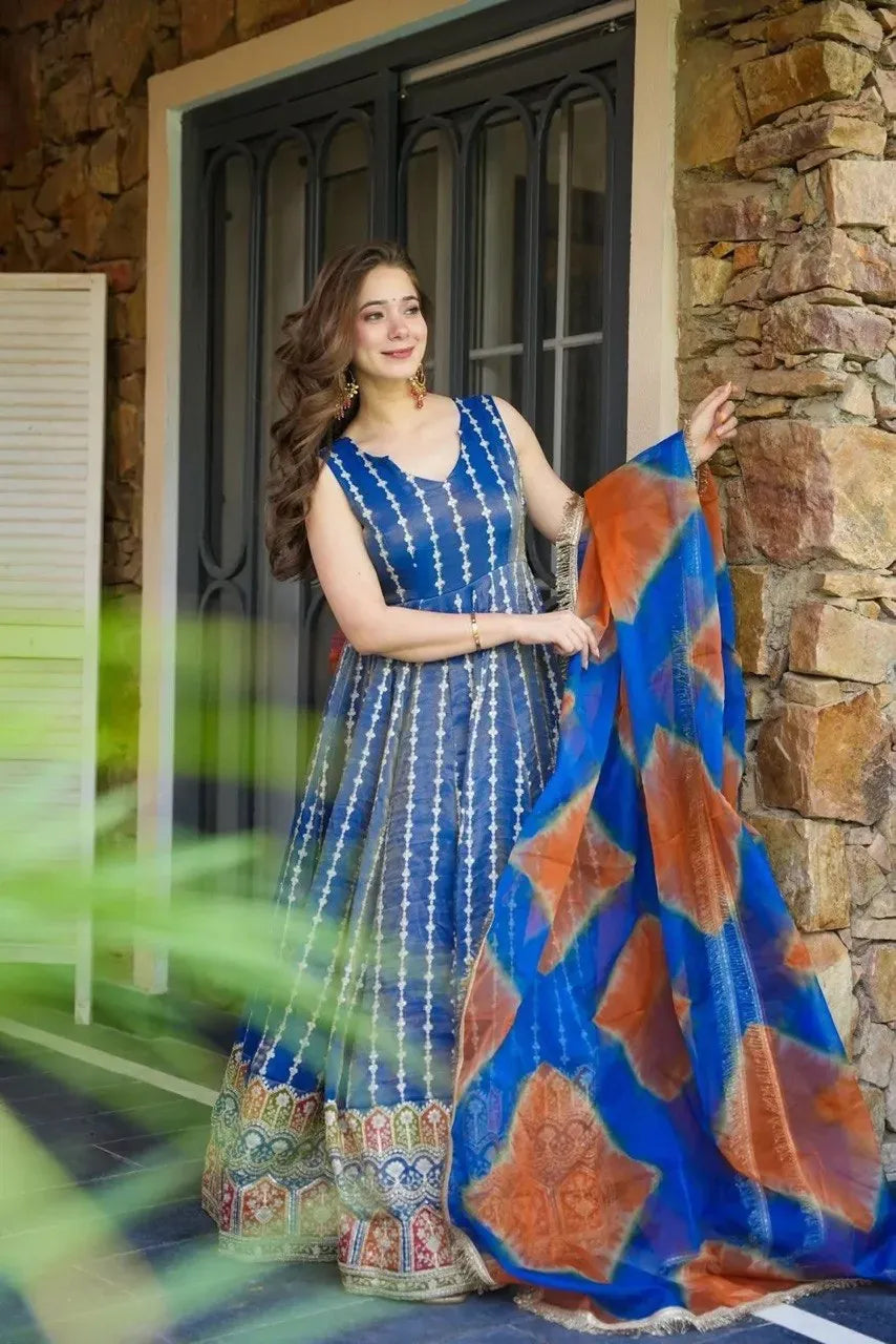Woman posing in blue digital printed organza silk gown with heavy flair