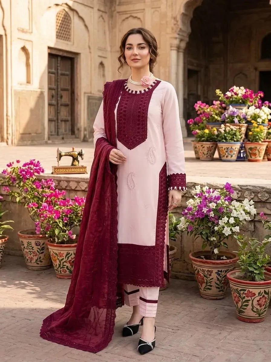 Model wearing light pink Pakistani suit set with maroon dupatta outdoors