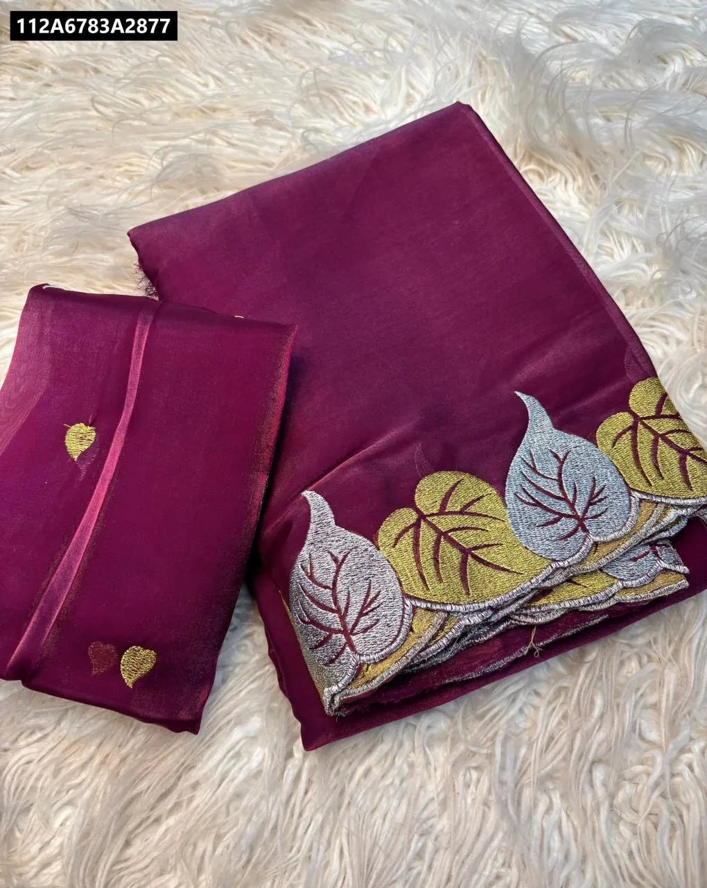 Elegant purple Jimmy Choo fabric saree with a delicate leaf cutwork border and matching running blouse piece, presented as a flat lay.
