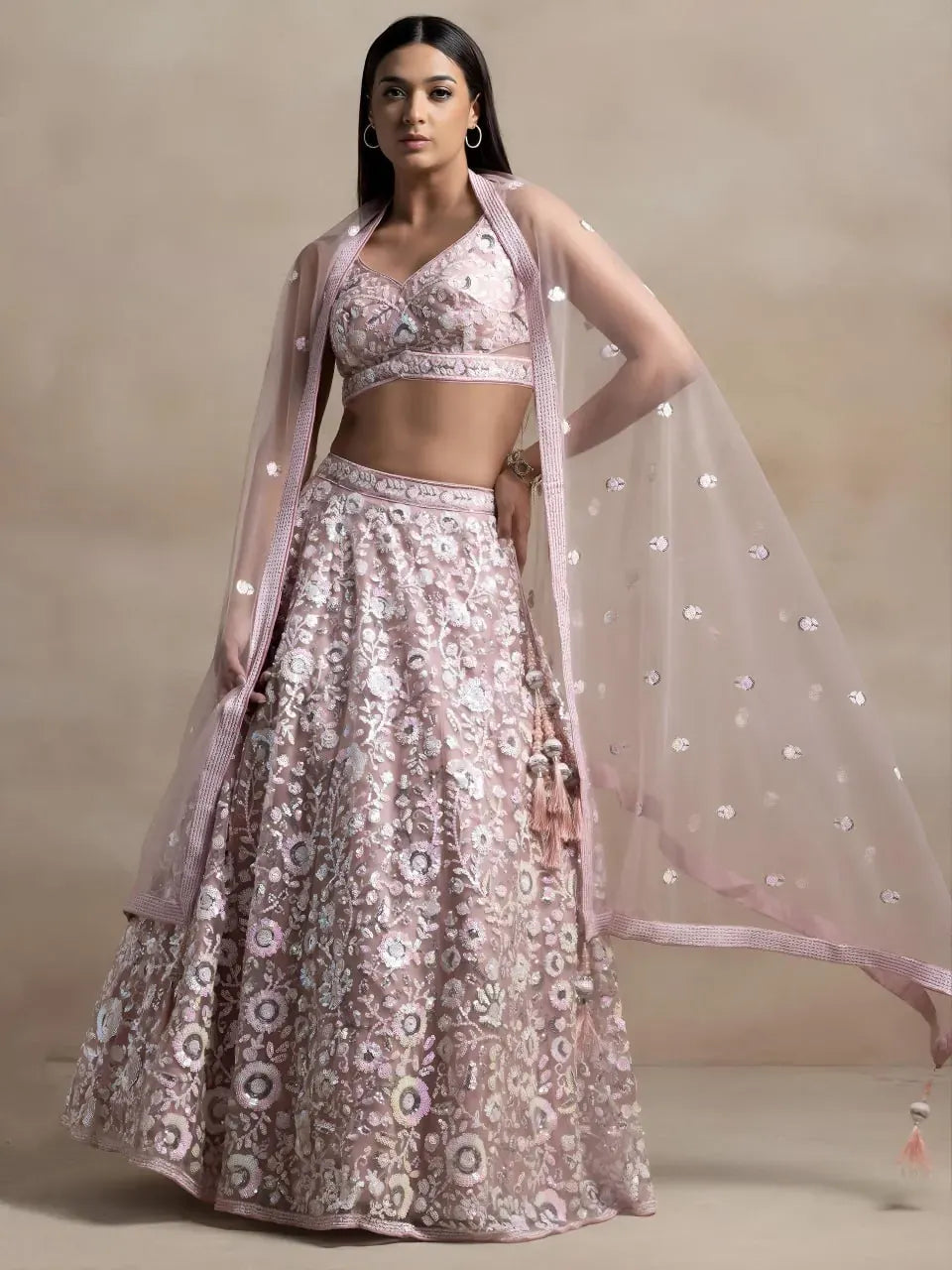 Model wearing pink floral sequin embroidered lehenga choli with dupatta