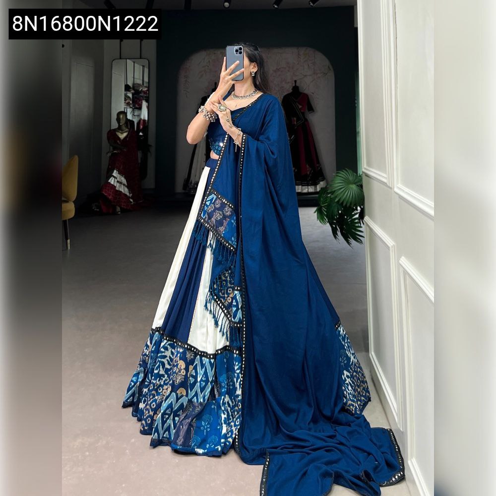 Front full body view of a woman in a royal blue and white printed rayon lehenga choli with mirror work, gota patti, and patterned border