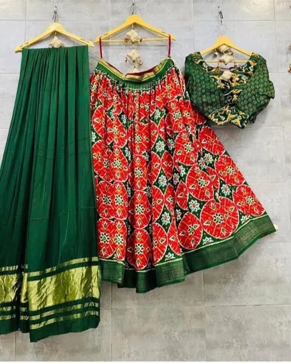 Green and red patterned pure silk lehenga set on hangers