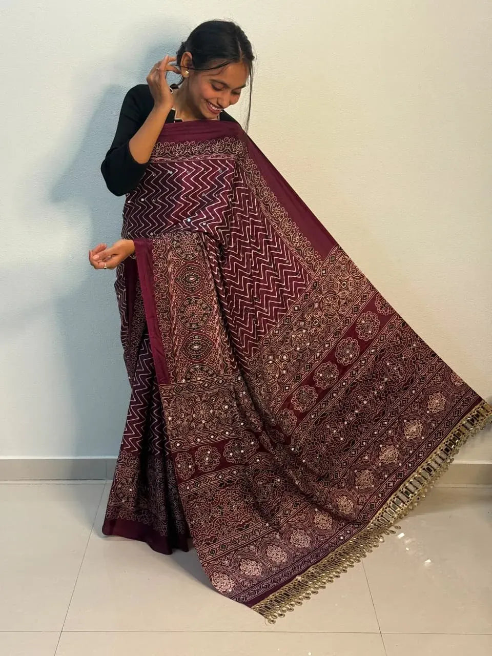 Model wearing maroon viscose silk saree with mirror work