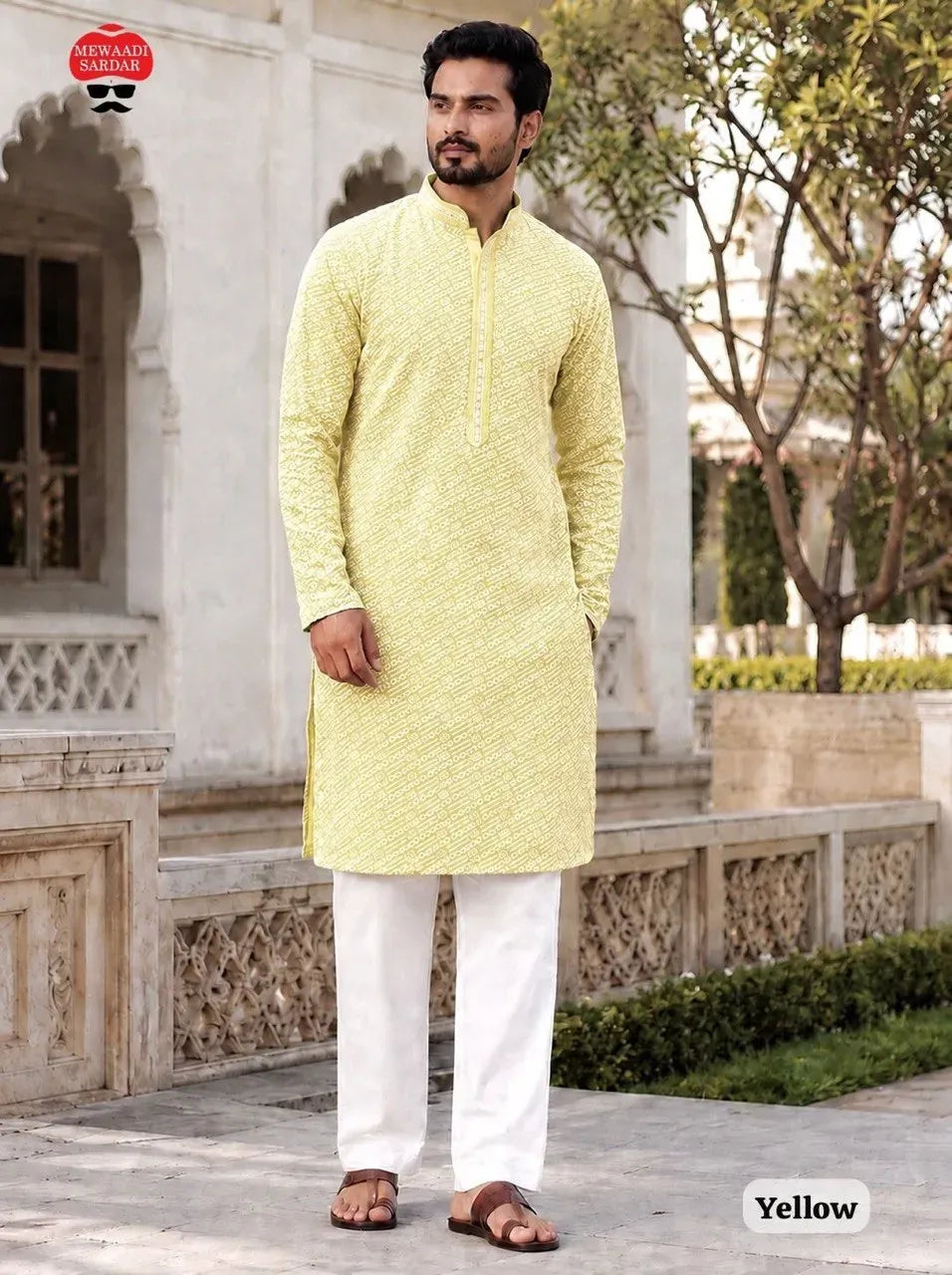 Model standing outdoors wearing yellow rayon chikan kurta with white pyjama