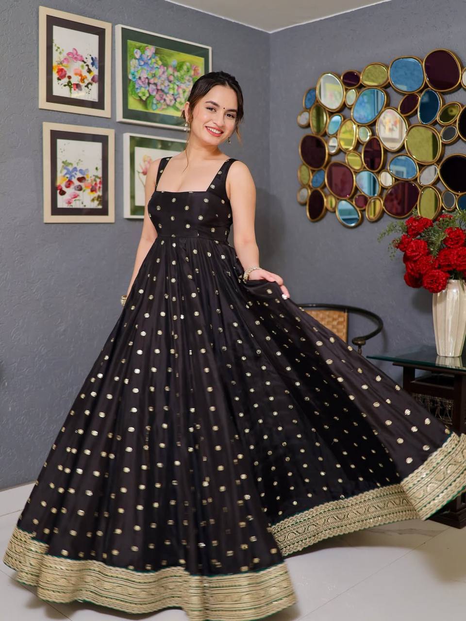 Model posing gracefully in a black Designer Anarkali Suit Set with golden sequin and thread embroidery.