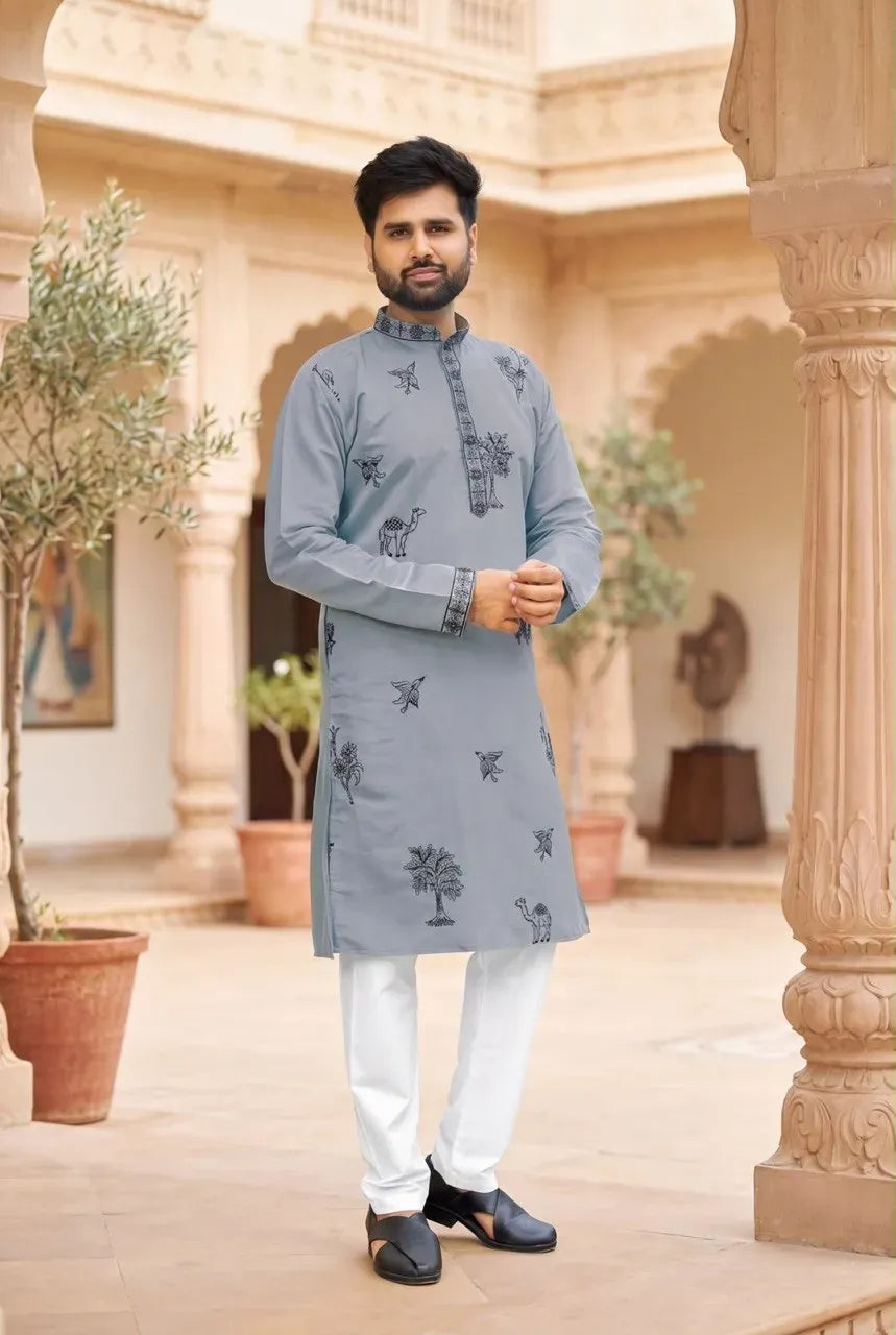 Man wearing grey embroidered roman silk kurta with white pyjama standing outdoors