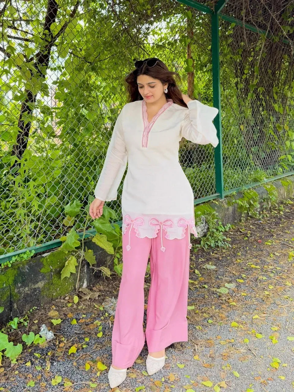 Full length view of model in white top and pink palazzo set