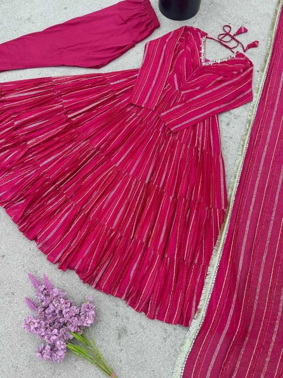 Model wearing magenta chanderi ruffle gown with full flair