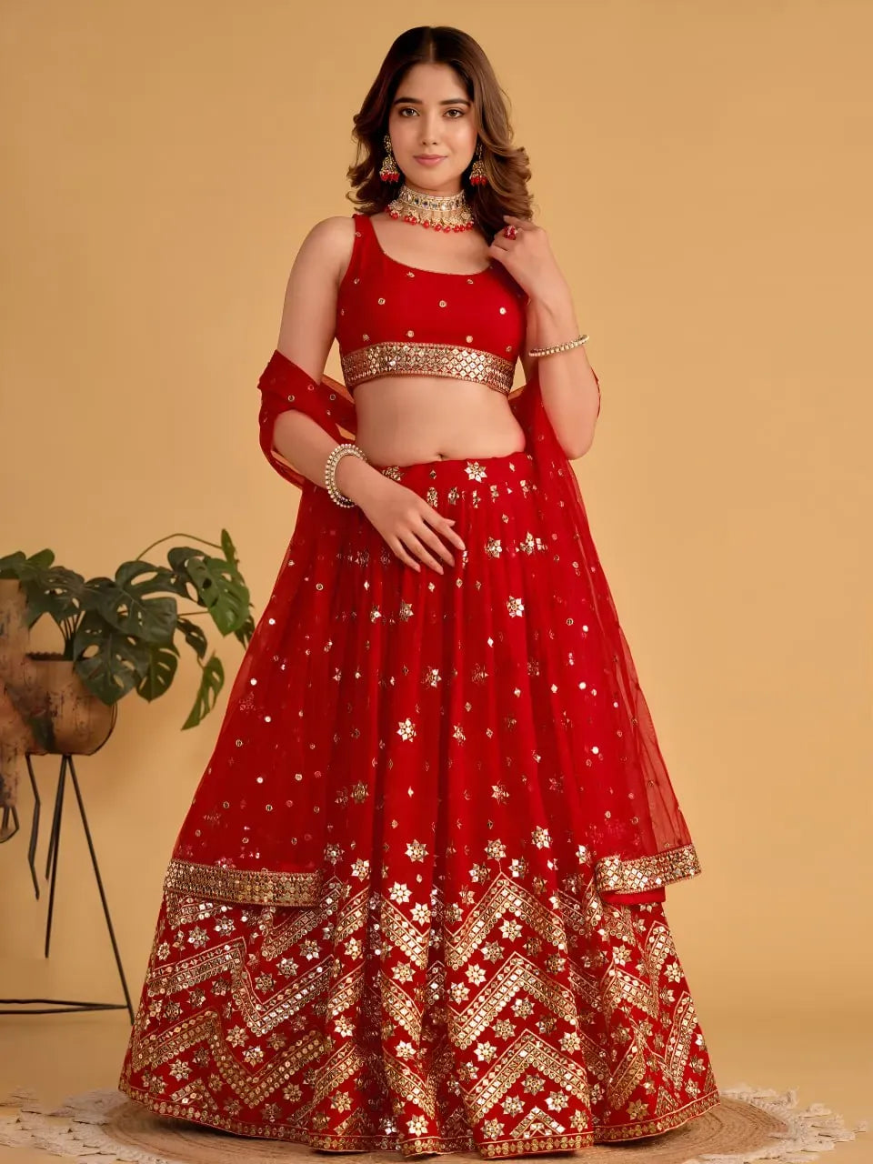 Model wearing front-facing scarlet red georgette lehenga with sequin embroidery