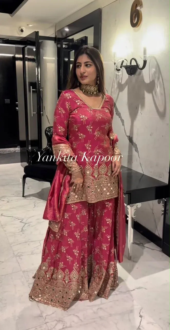 Model wearing pink shimmer silk sharara set with heavy embroidery