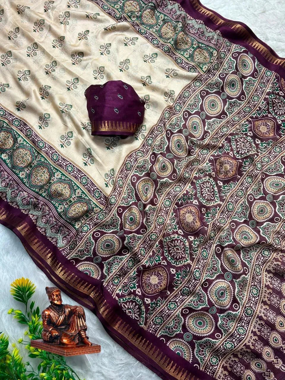 Cream and purple silk blend saree with intricate traditional print and matching blouse piece