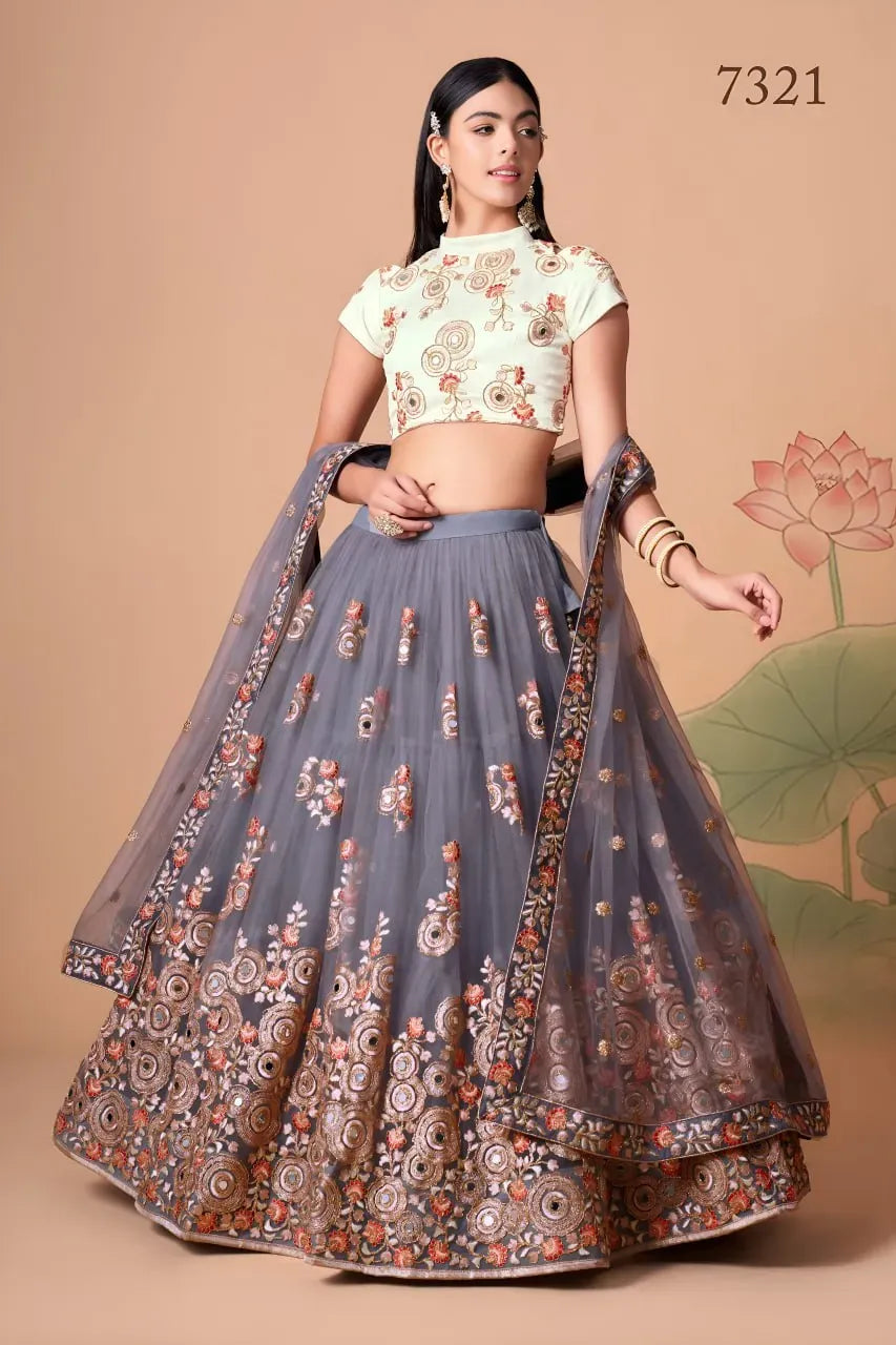 Front view of model wearing smoky grey embroidered lehenga and off-white blouse
