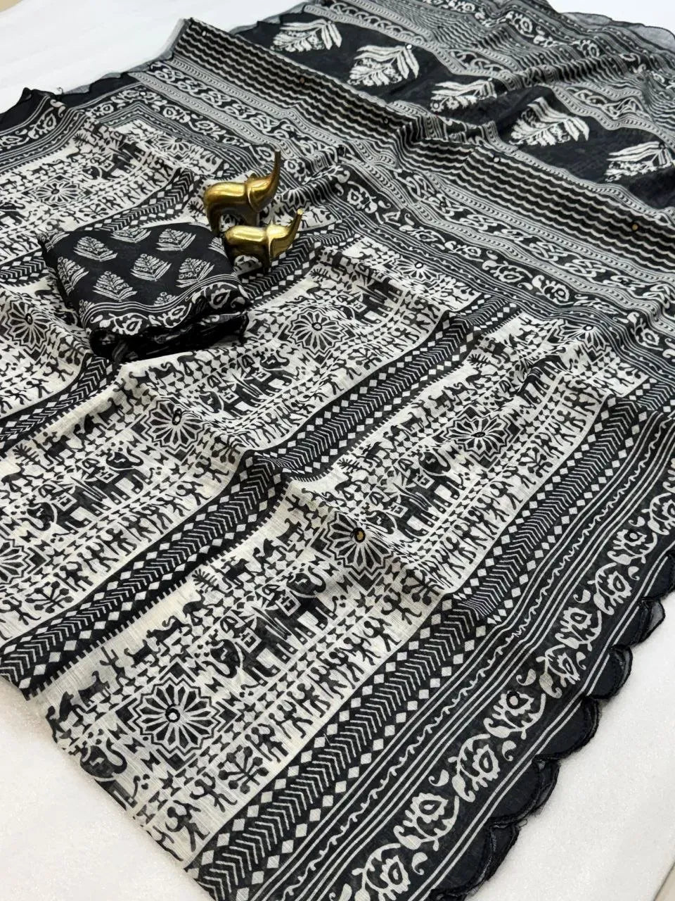 Black and white soft linen digital printed saree flat lay with folded blouse piece