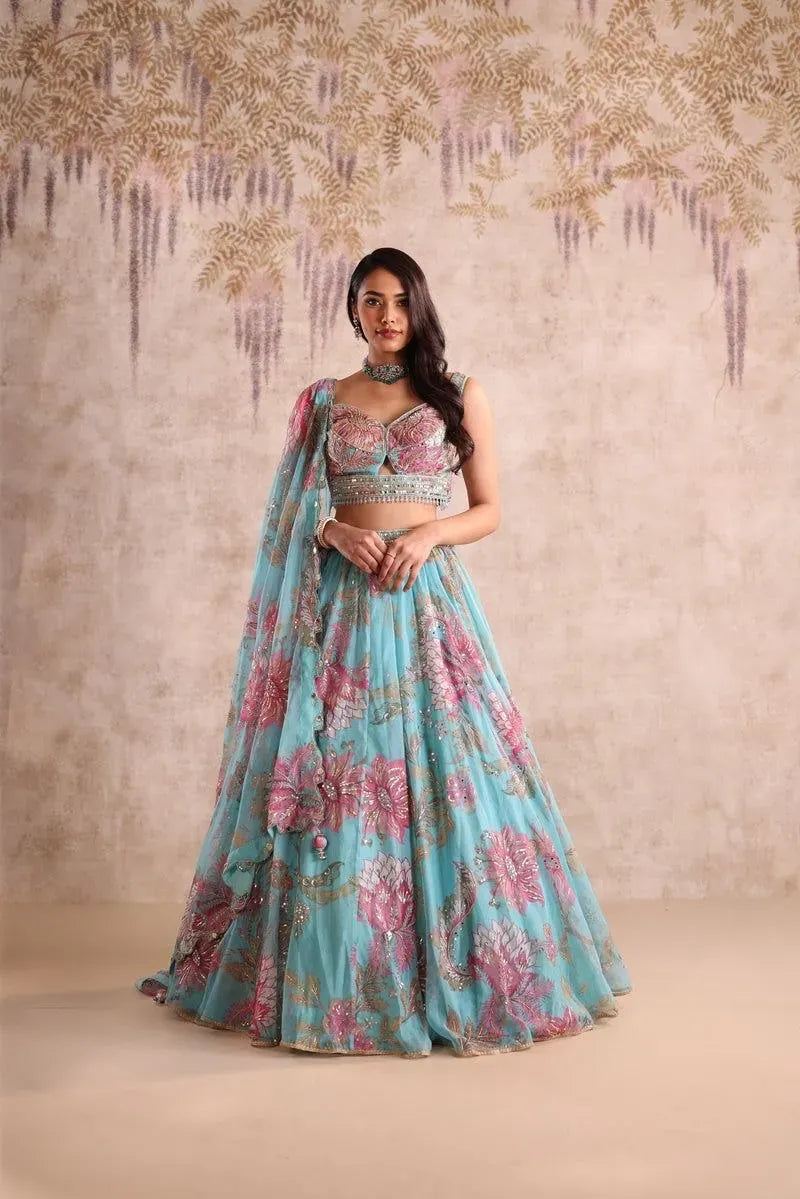 Model wearing blue floral digital print tabby silk lehenga with heavy blouse and dupatta