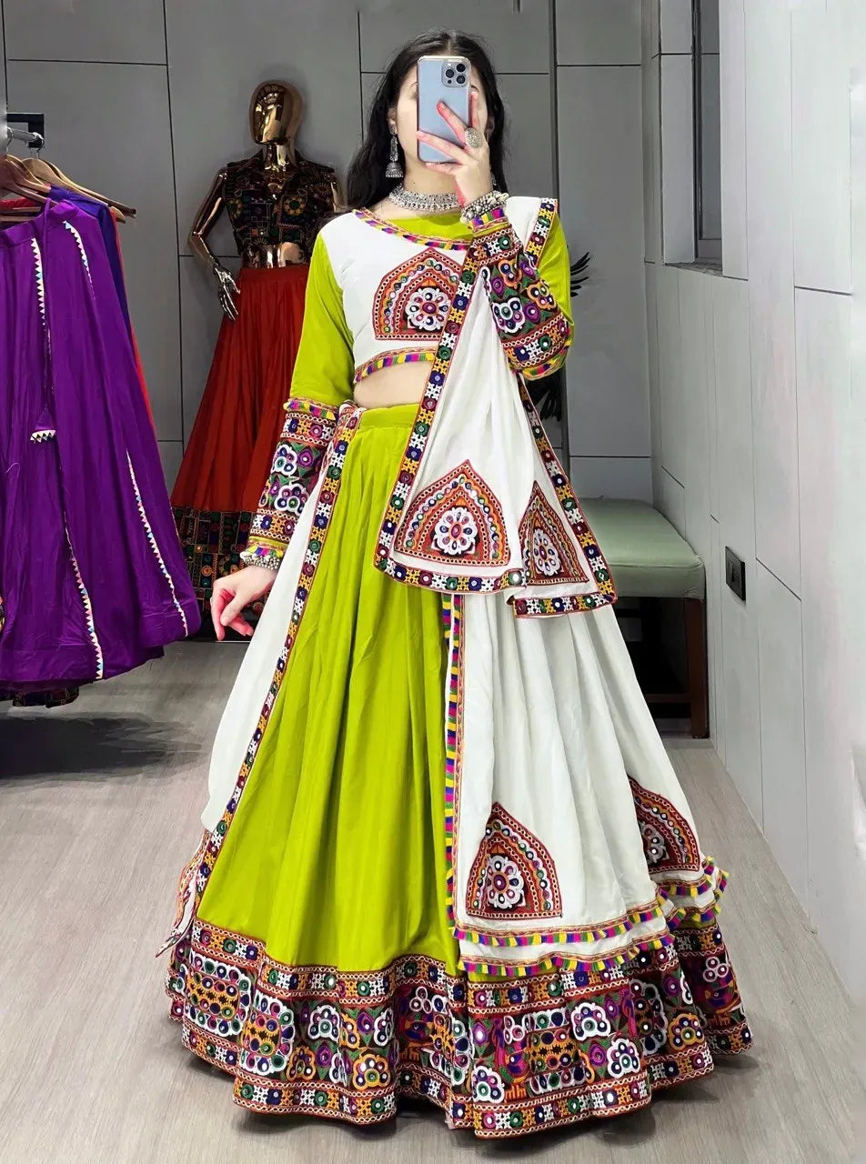 Woman wearing lime green and white gamthi work lehenga with mirror work