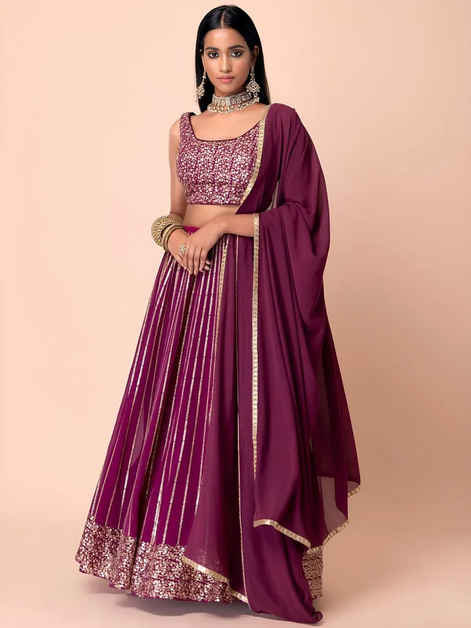 Full body view of model in wine georgette designer lehenga choli
