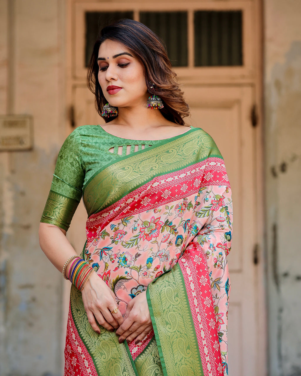 Close-up of woman showcasing the intricate floral digital print on the silk saree and the elegant green blouse with cutout detail.