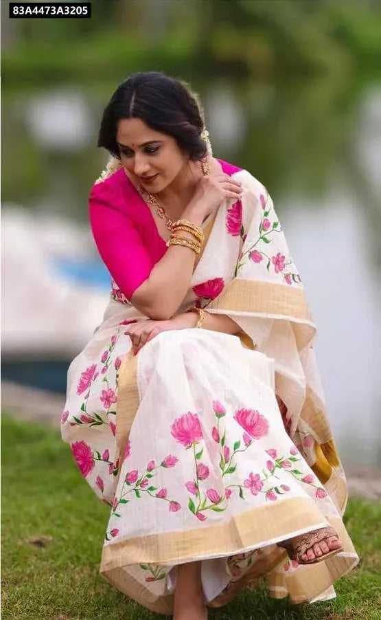 Model in Cream Pink Floral Digital Print Linen Saree, sitting on grass, looking elegant.