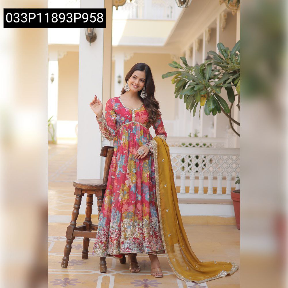 Smiling woman in a vibrant floral digital printed and embroidered Anarkali suit with a mustard yellow dupatta, posing gracefully.