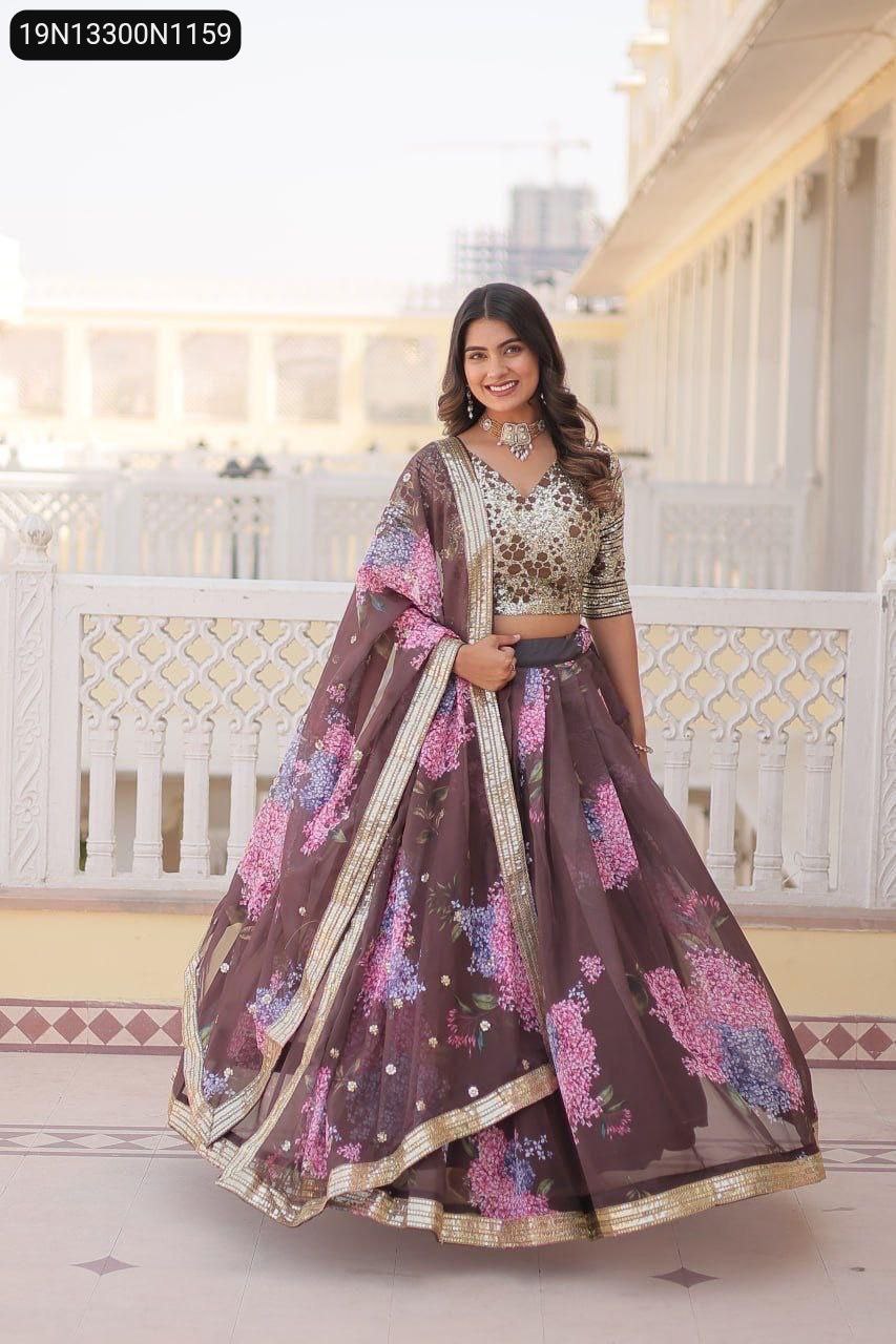 Full shot of a smiling model in a coffee-colored digital printed Russian silk lehenga choli with sequins embroidered blouse, standing front.