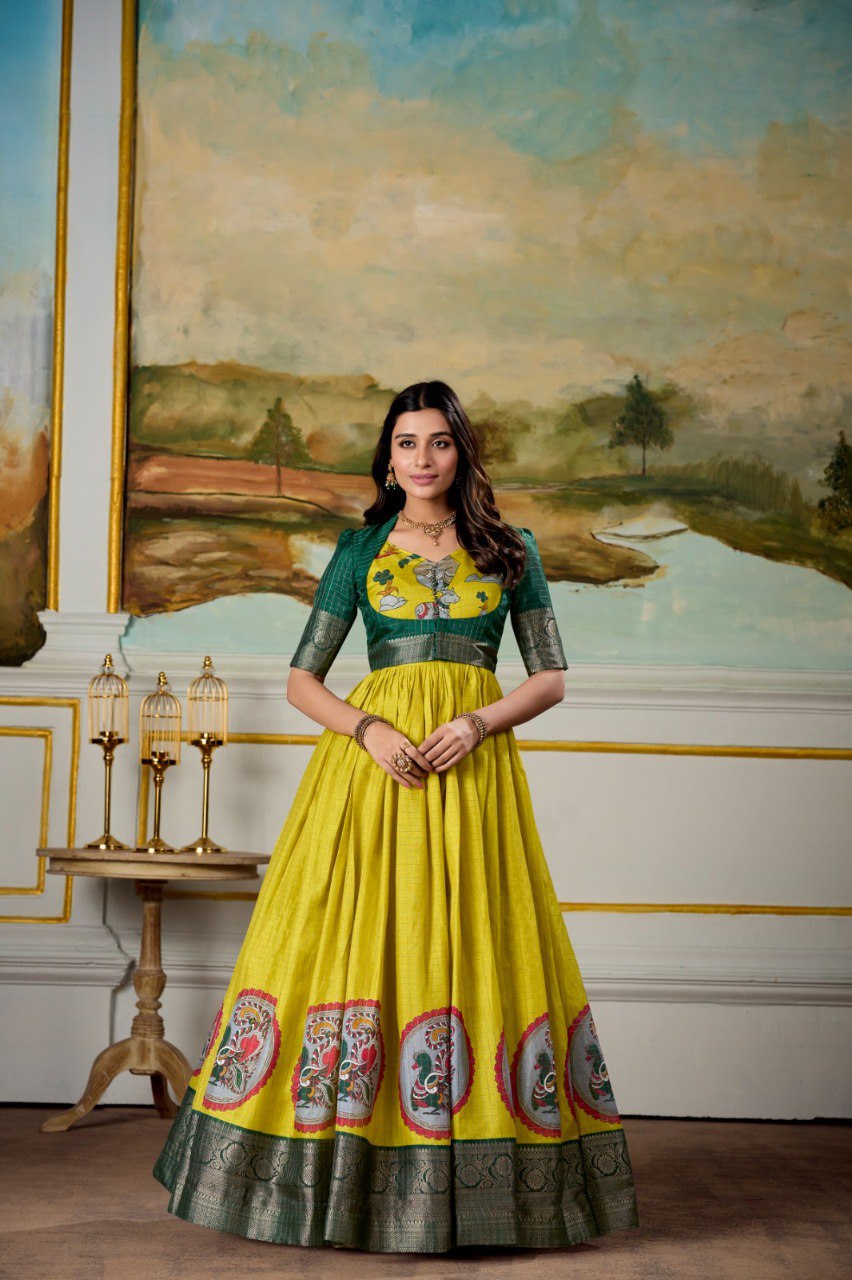 Woman posing elegantly in TRENDBUY's Green and Yellow Dola Silk Kalamkari Print Gown with Koti.