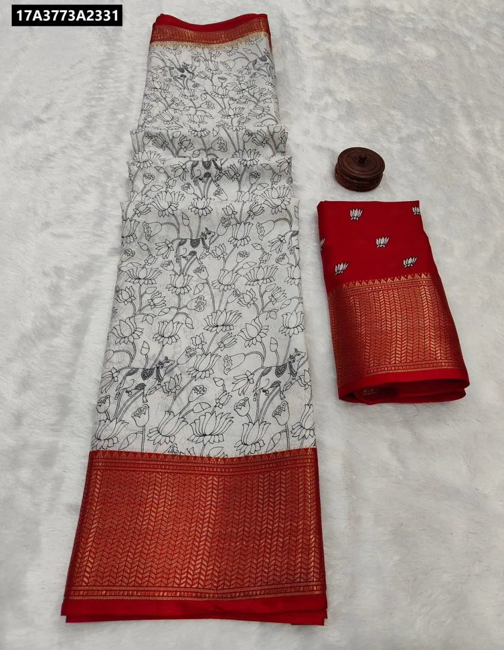 TRENDBUY Dola Silk Saree with White body and black Kalamkari style print, featuring a vibrant red zari woven border, accompanied by a matching red blouse piece.