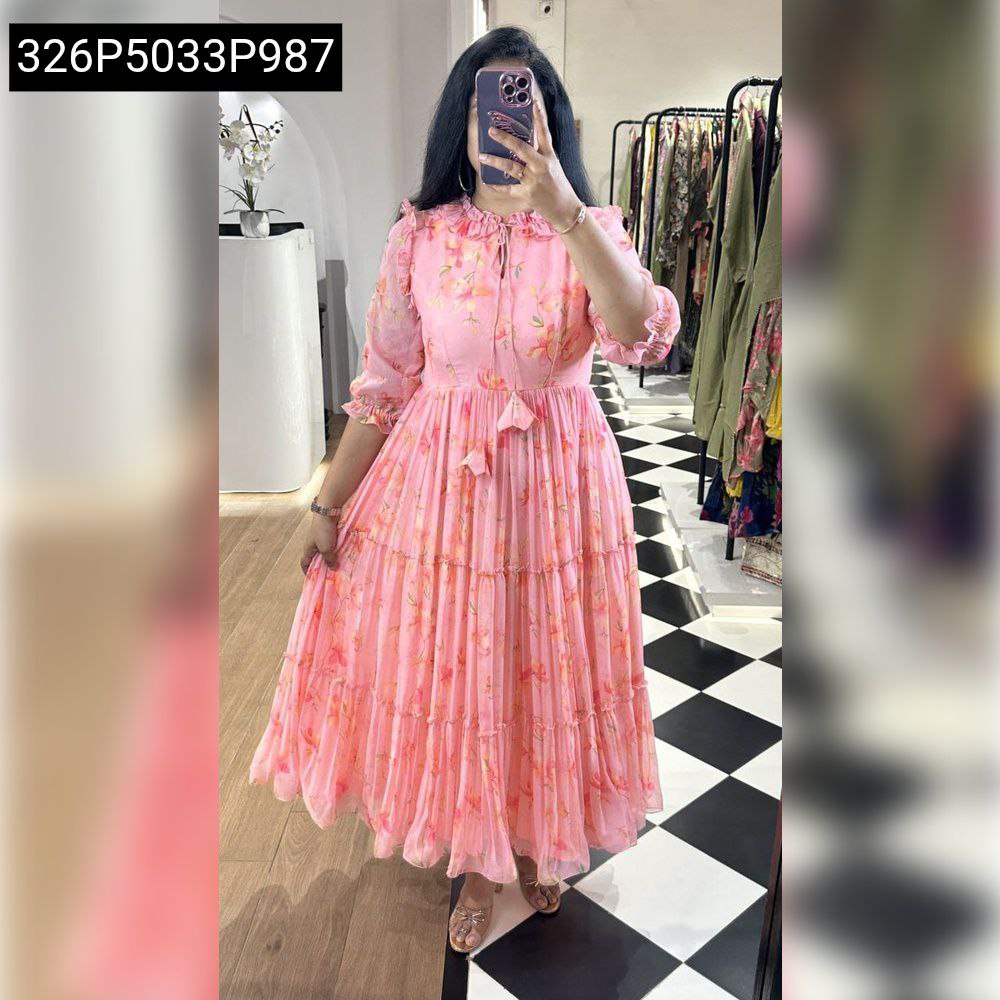 Full body shot of a woman modeling a pink floral georgette tiered maxi dress, showcasing the flowy silhouette and elegant design.