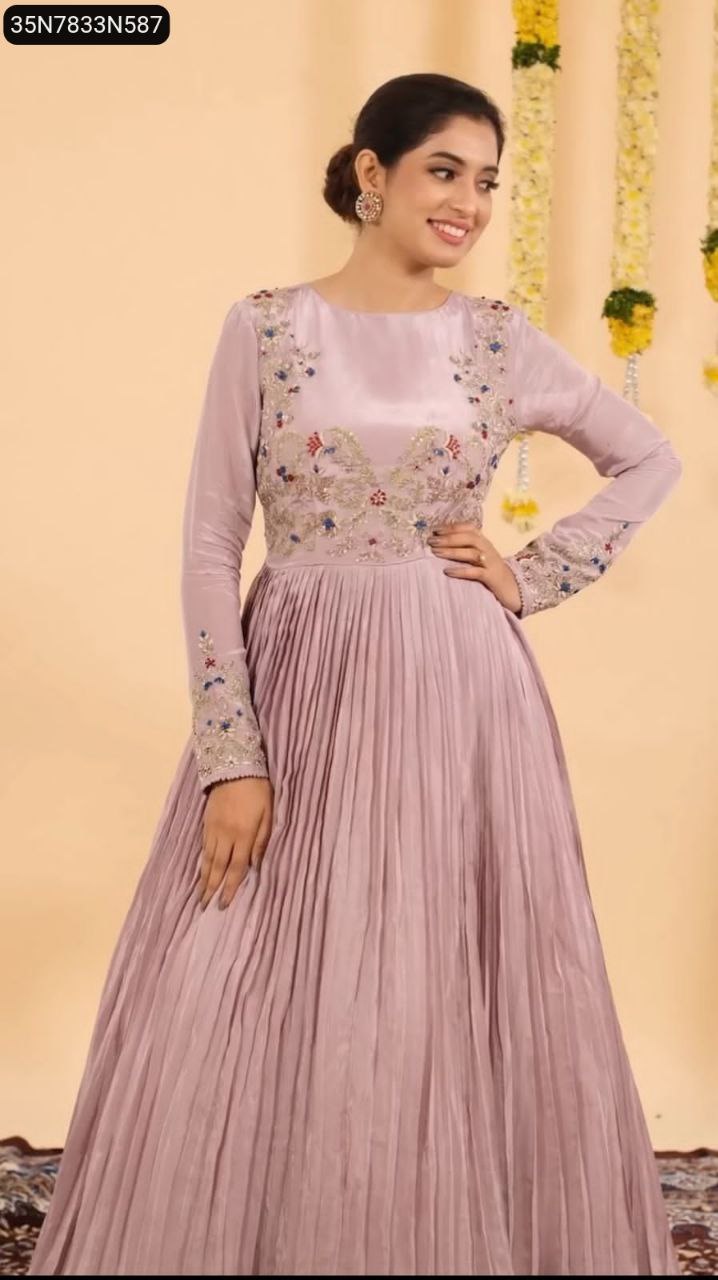 Woman posing elegantly in a lavender embroidered Chinon gown, front view.