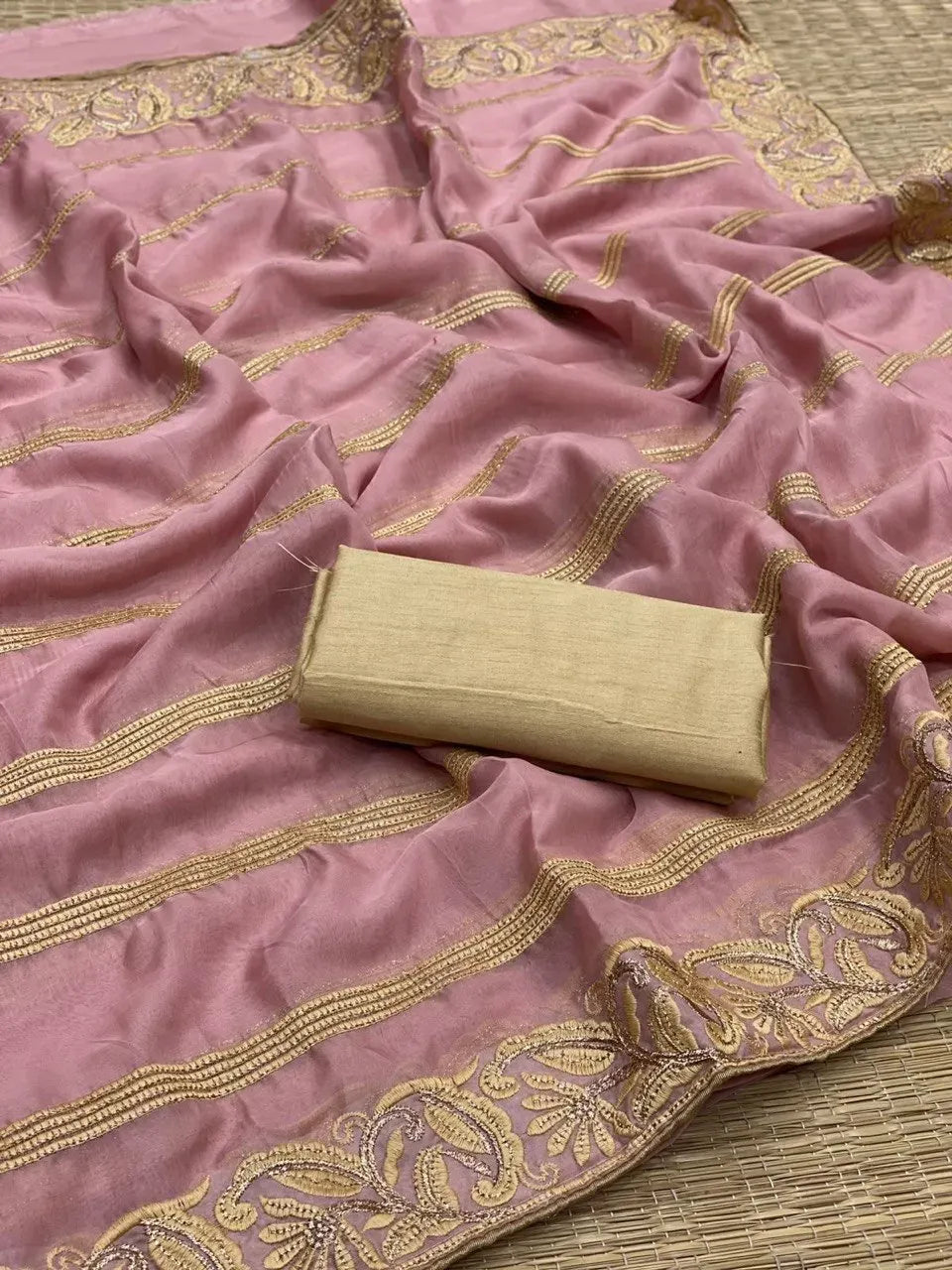 Onion pink georgette saree with golden zari embroidery stripes and a gold silk unstitched blouse piece