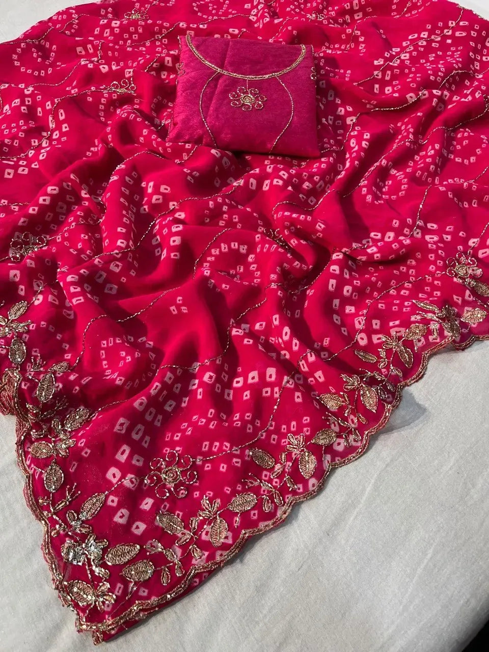 Raani pink georgette bandhej saree draped with matching heavy embroidered unstitched mono blouse fabric