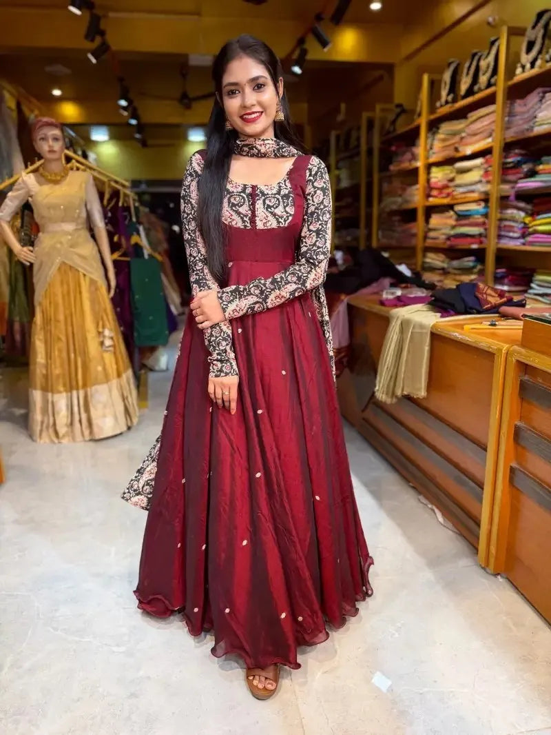 Woman wearing a premium maroon sparkling georgette gown with printed sleeves and matching Chanderi dupatta