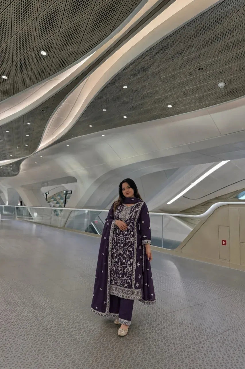 Model wearing deep purple georgette embroidery kurti and Farsi palazzo set in a modern indoor hallway
