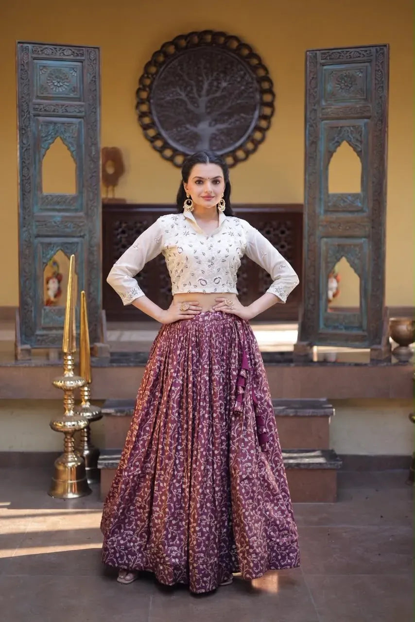 Model in wine jacquard lehenga and cream embroidered blouse with beads