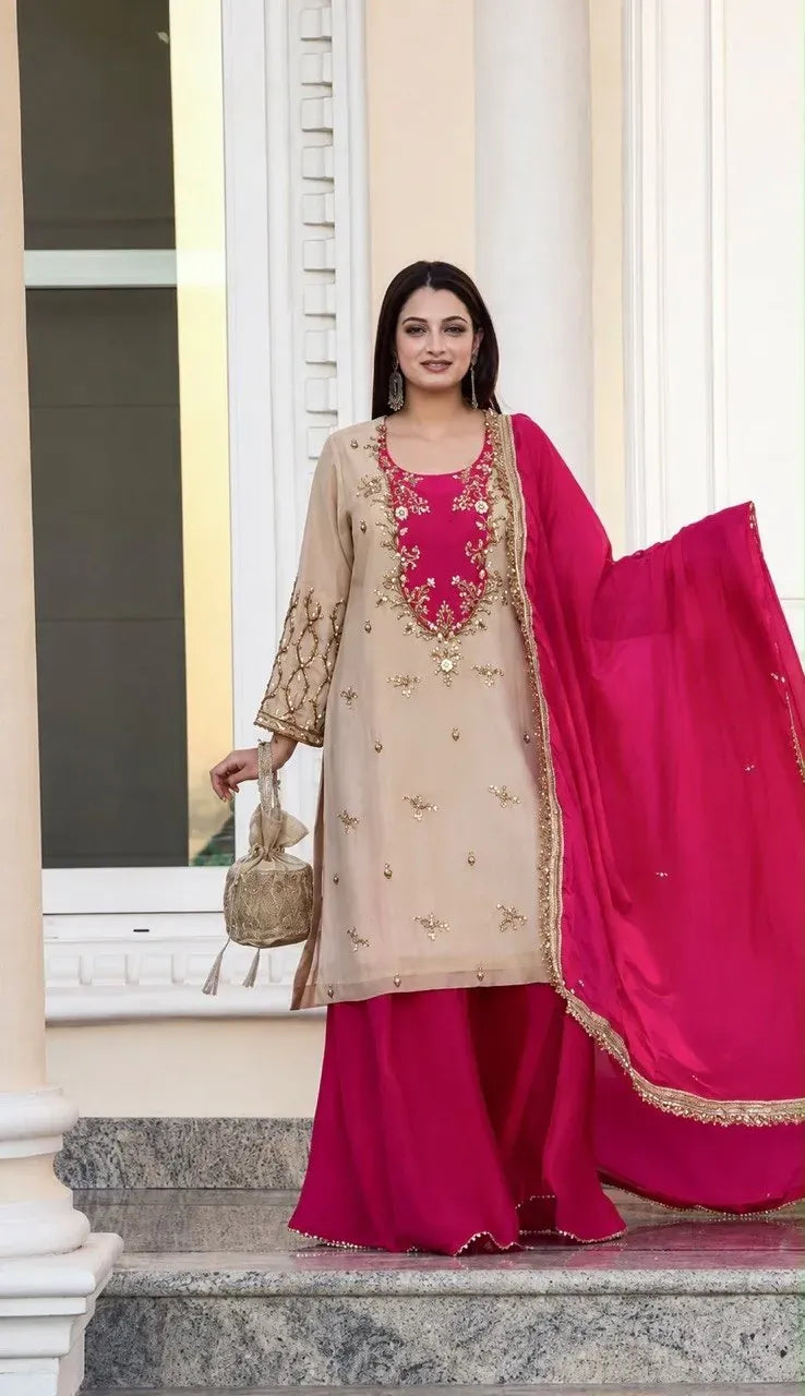 Model posing in beige maska cotton kurti with magenta pink chinon silk palazzo and dupatta holding a golden potli bag