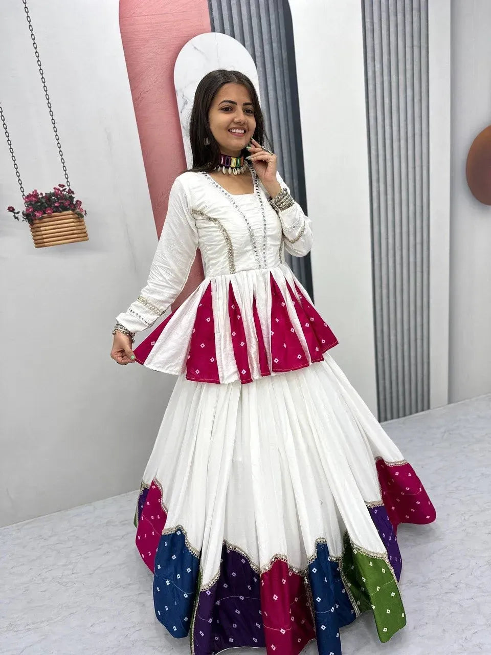 Front view of woman wearing elegant white cotton festive lehenga set with a flared multicolor border