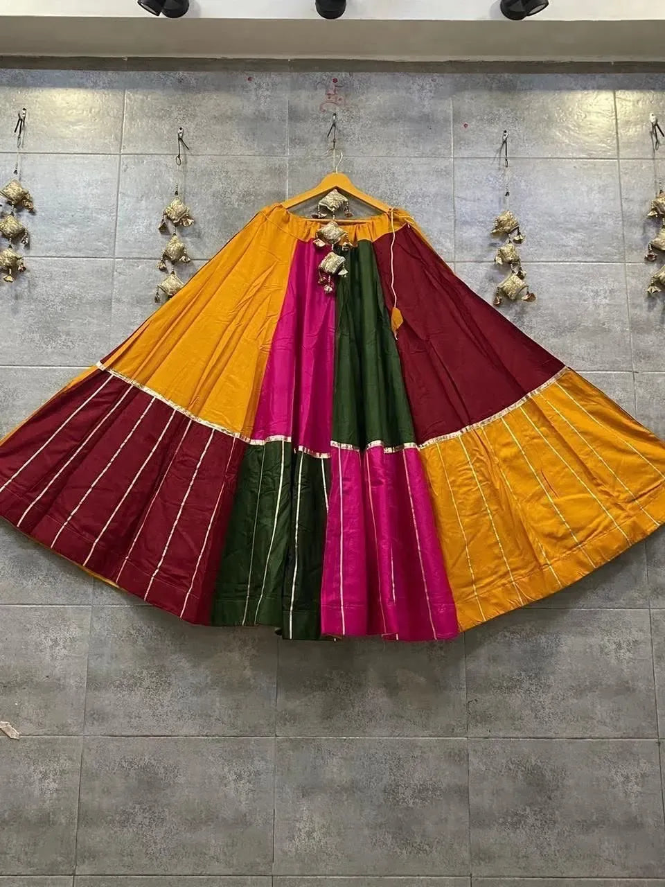 Multicolor paneled rayon festive skirt featuring yellow, green, pink, and maroon segments with gold trim