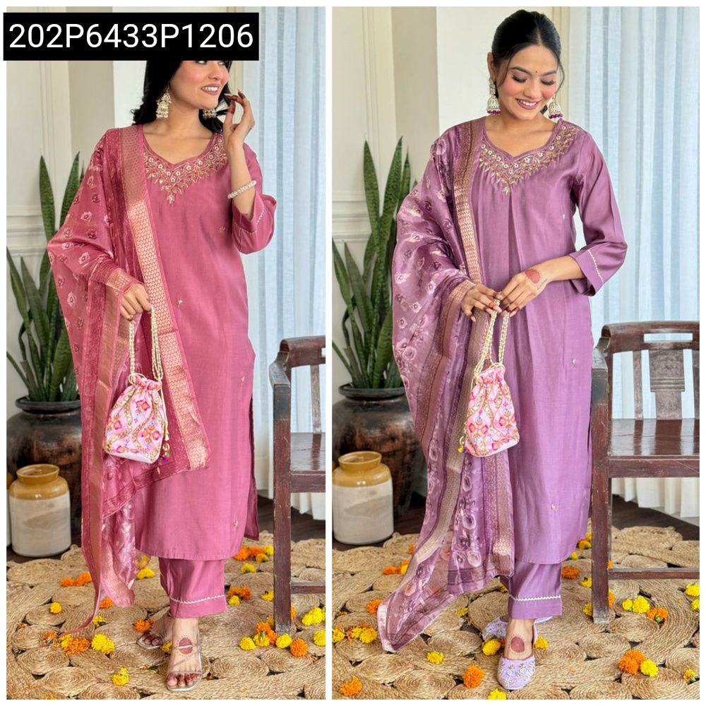 Woman posing elegantly in a pink Roman Silk handwork suit with Chanderi dupatta.