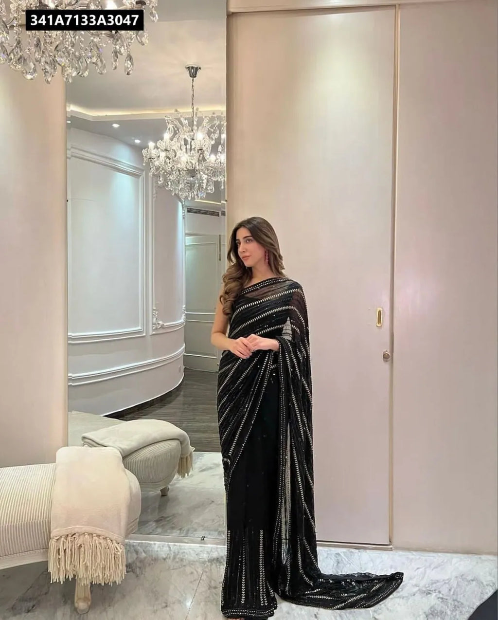 Model wearing a black sequin work georgette saree with a mono silk blouse, full shot, front-facing, elegant indoor setting
