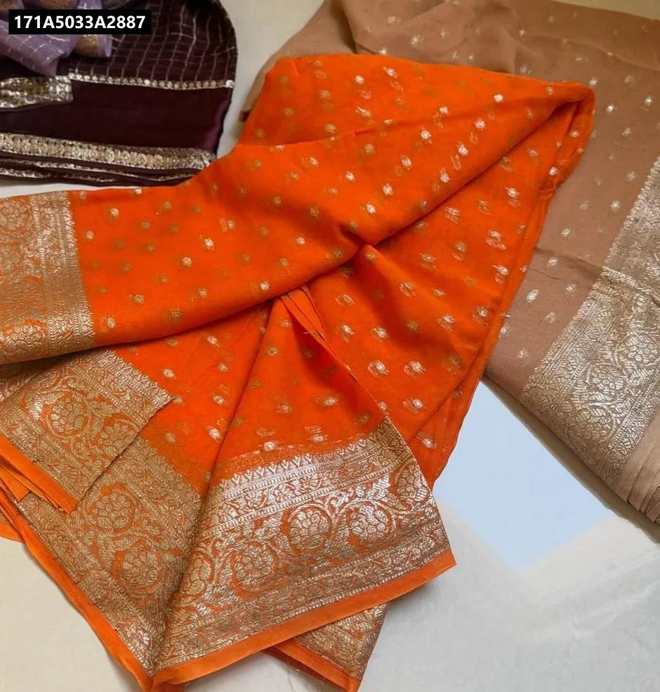Vibrant orange Viscose Georgette saree with intricate gold border on flat lay.