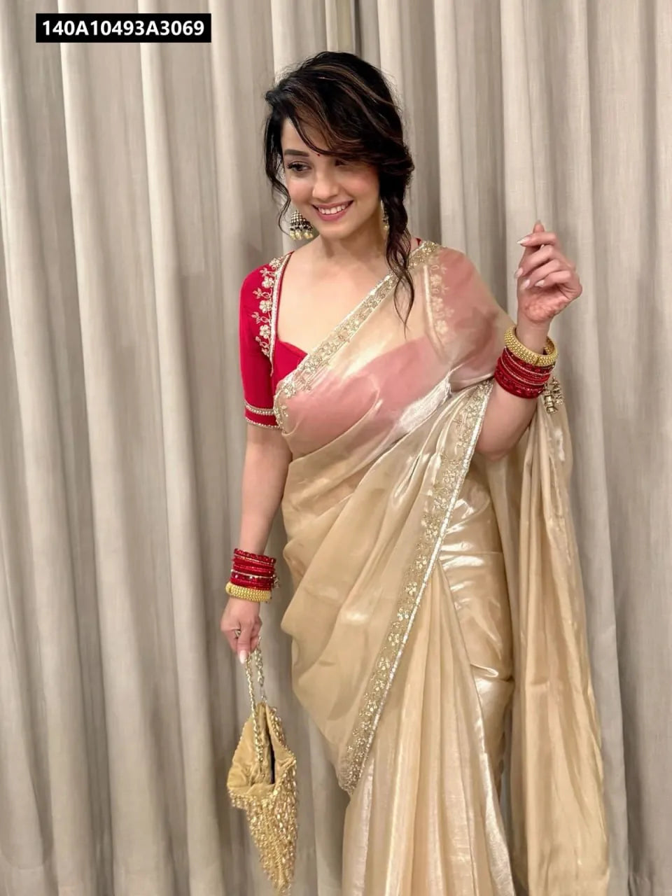 Model wearing Gold Embellished Saree with Red Blouse for Festive Occasion