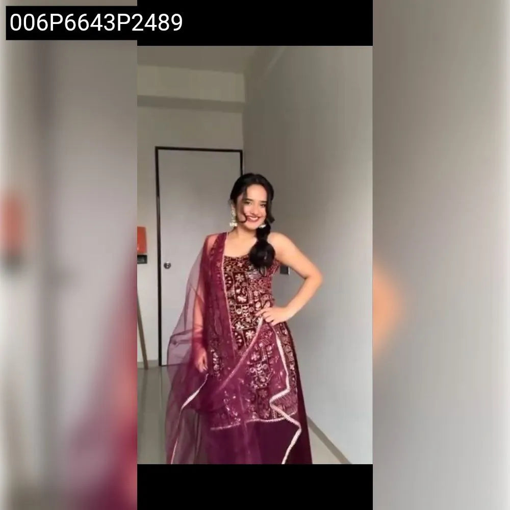 Full body front view of a woman posing elegantly in a maroon embroidered A-line sharara kurti set with a dupatta.