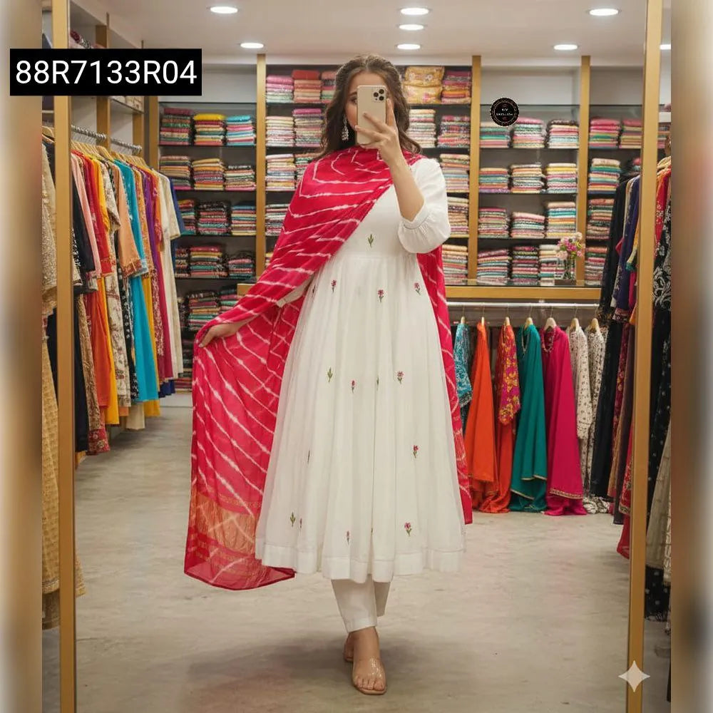 Model posing in white embroidered Chanderi Anarkali kurti set with red leheriya dupatta, front view in a boutique.